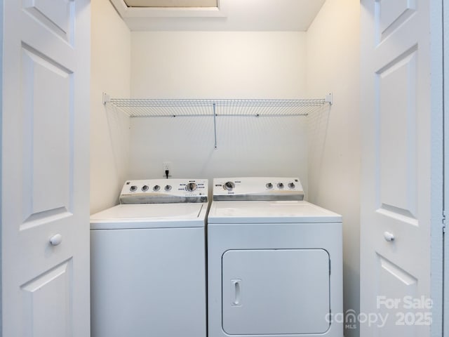 washroom with washing machine and clothes dryer