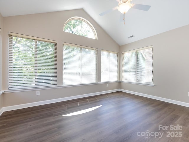 spare room featuring ceiling fan, dark hardwood / wood-style flooring, and high vaulted ceiling