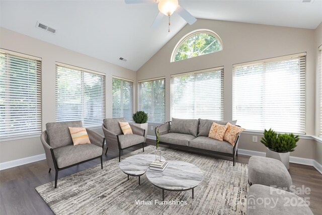 living room featuring dark wood-type flooring, high vaulted ceiling, and ceiling fan