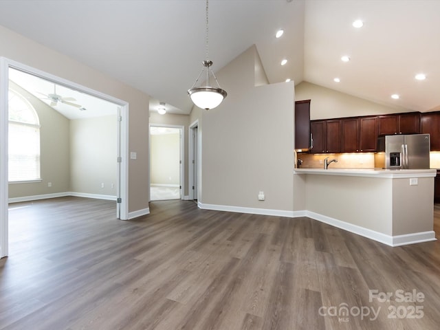 kitchen featuring hanging light fixtures, stainless steel refrigerator with ice dispenser, hardwood / wood-style flooring, and dark brown cabinets