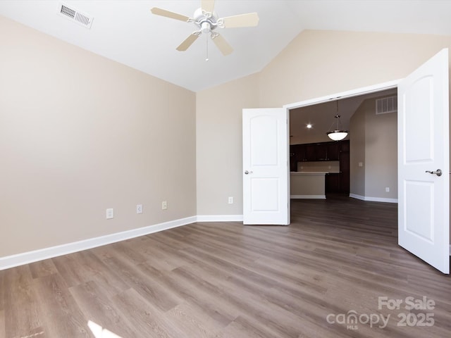 interior space featuring hardwood / wood-style flooring, ceiling fan, and vaulted ceiling