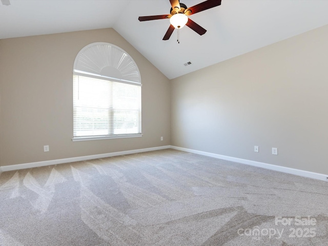 carpeted empty room featuring lofted ceiling and ceiling fan