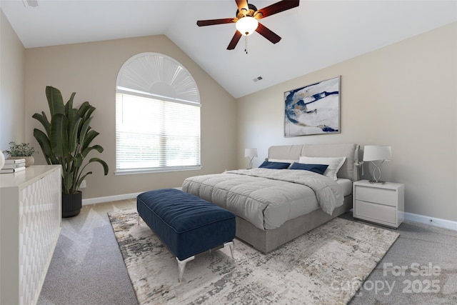 bedroom with ceiling fan, vaulted ceiling, and light carpet