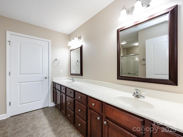 bathroom with vanity, tile patterned flooring, and a shower with shower door