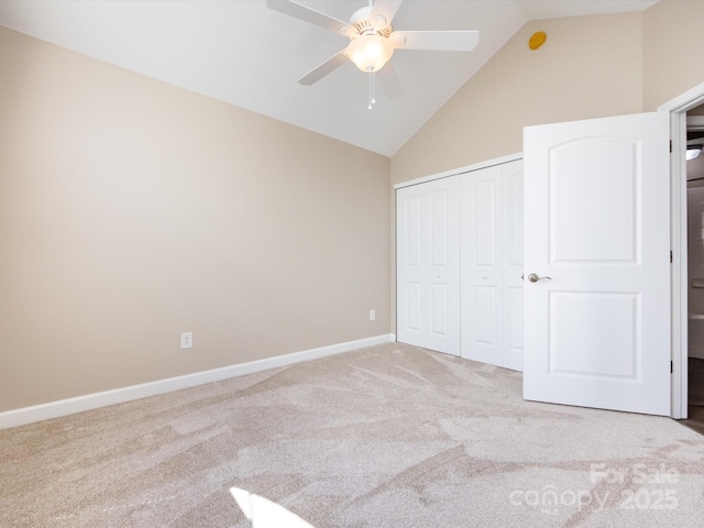 unfurnished bedroom with light carpet, high vaulted ceiling, a closet, and ceiling fan