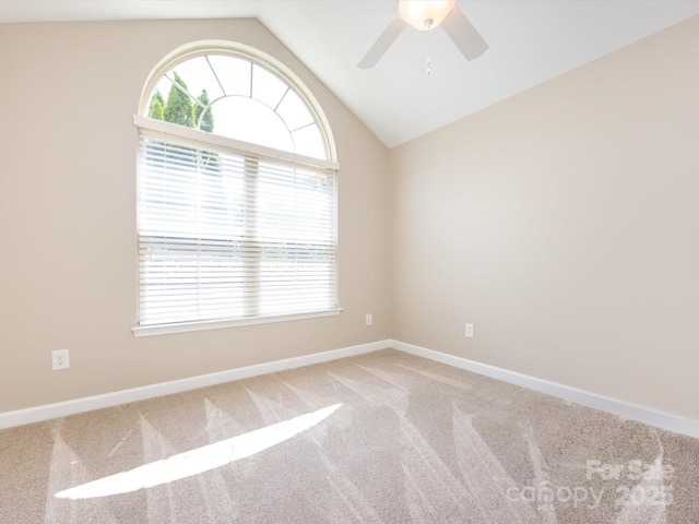 spare room featuring lofted ceiling, carpet floors, and ceiling fan