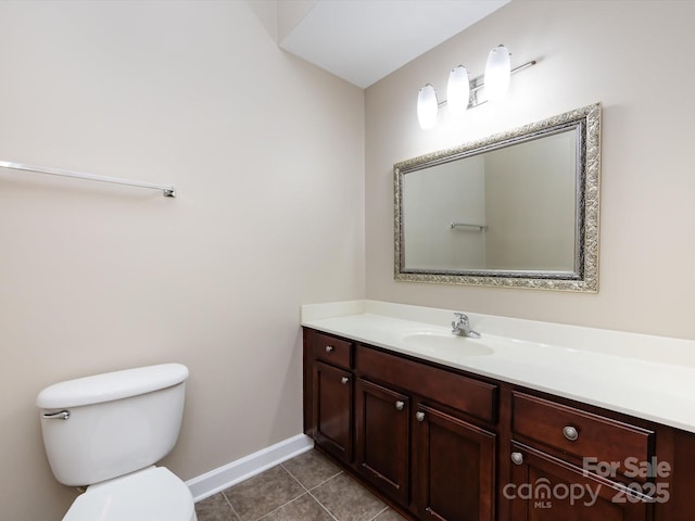 bathroom with tile patterned flooring, vanity, and toilet