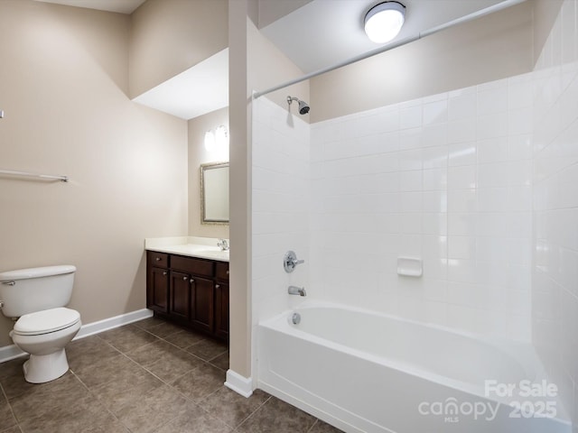 full bathroom with vanity, tiled shower / bath, tile patterned floors, and toilet