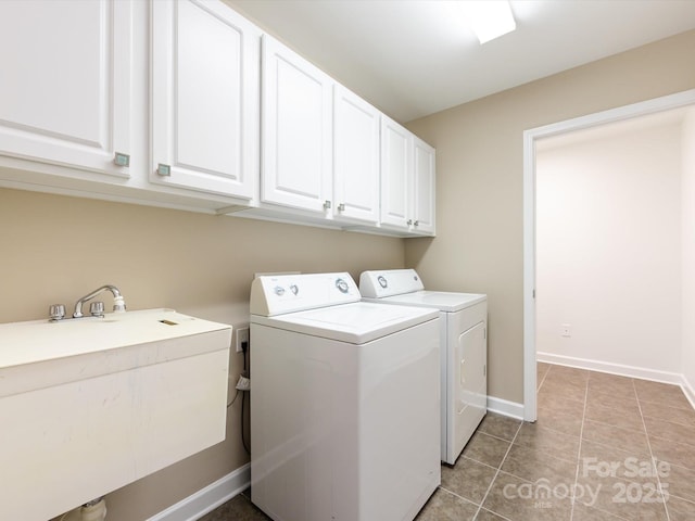 laundry area with separate washer and dryer, sink, light tile patterned floors, and cabinets