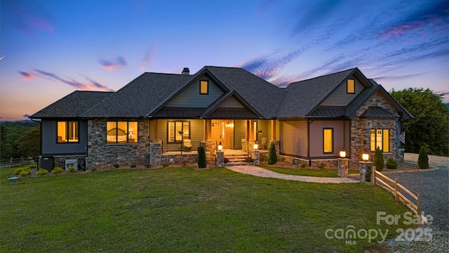 craftsman inspired home featuring a yard and covered porch