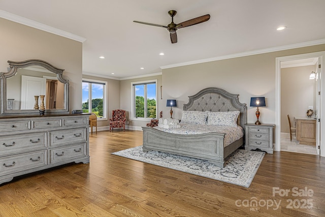 bedroom featuring ornamental molding and light hardwood / wood-style flooring