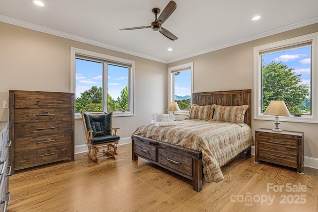 bedroom featuring ceiling fan, ornamental molding, and light wood-type flooring