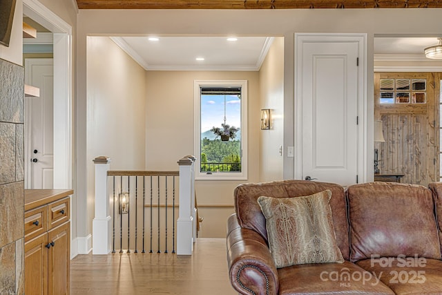 living room with crown molding and light wood-type flooring