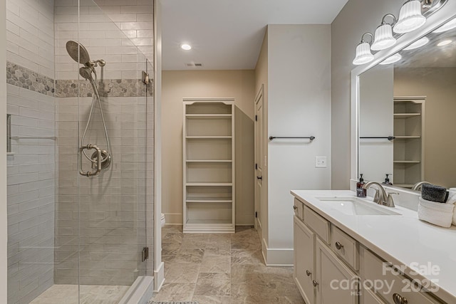 bathroom featuring walk in shower and vanity