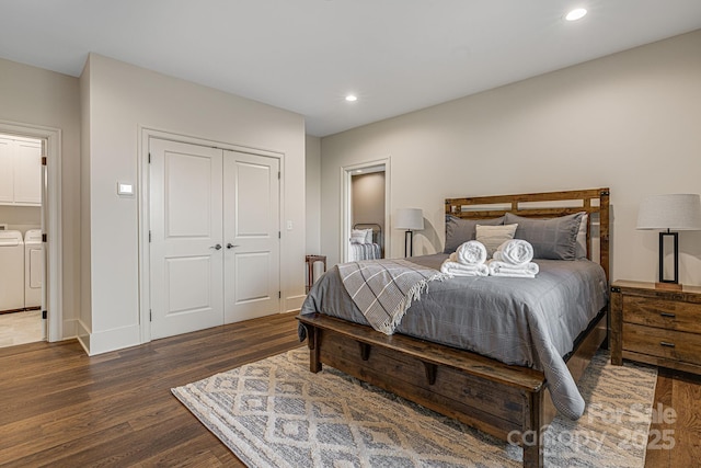 bedroom with a closet, dark hardwood / wood-style flooring, and washer and dryer