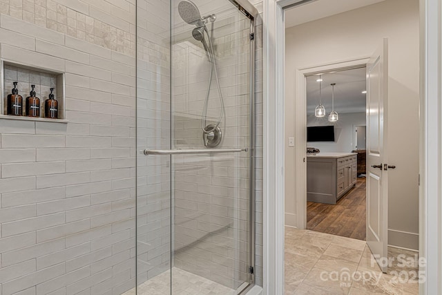 bathroom featuring vanity, tile patterned flooring, and a shower with door