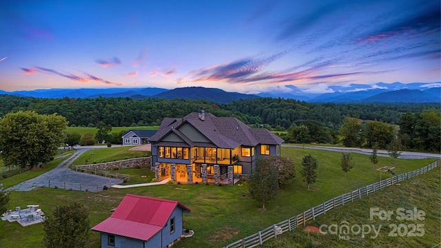 back house at dusk featuring a mountain view