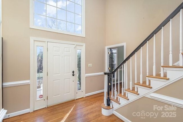 entryway with a high ceiling and hardwood / wood-style floors