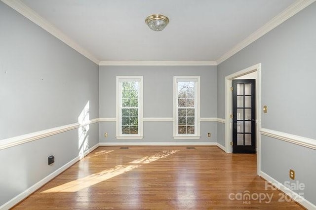 unfurnished room with hardwood / wood-style flooring and ornamental molding