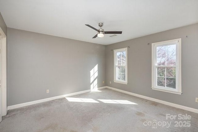 spare room with light colored carpet and ceiling fan