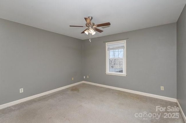 carpeted spare room featuring ceiling fan