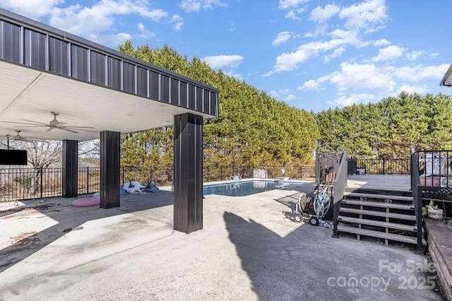 view of patio with ceiling fan and a swimming pool side deck