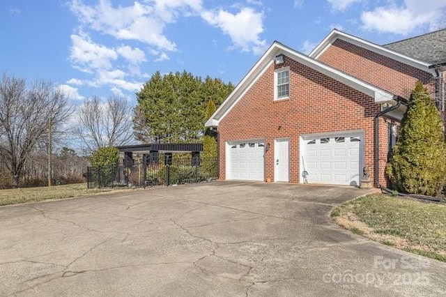 view of home's exterior with a carport and a garage