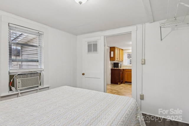 bedroom featuring cooling unit and multiple windows