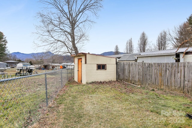 view of yard featuring a mountain view and a storage shed