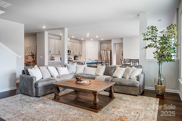 living room with baseboards, dark wood-type flooring, visible vents, and recessed lighting