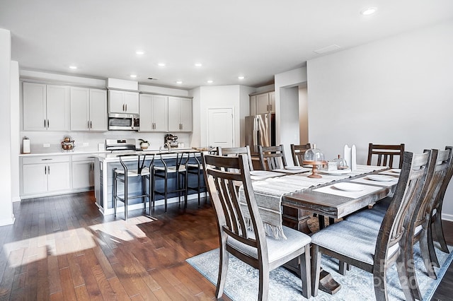 dining area featuring dark wood-style floors and recessed lighting