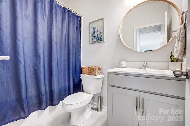 full bathroom featuring vanity, tile patterned flooring, and toilet