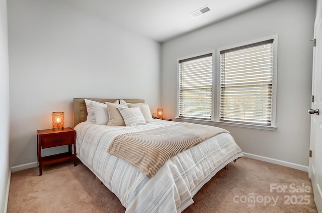 bedroom featuring baseboards, visible vents, and light colored carpet