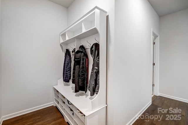 mudroom with dark wood-style flooring and baseboards