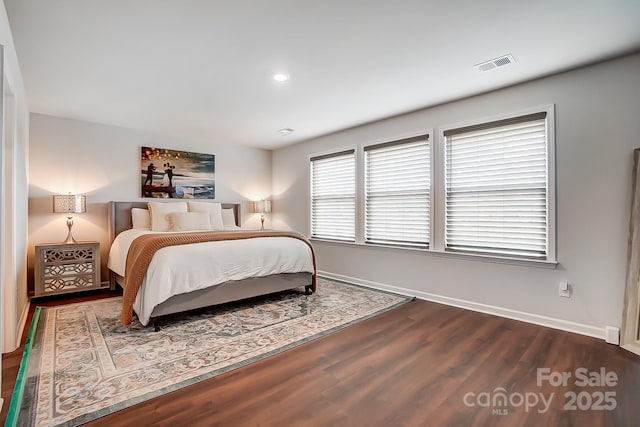 bedroom with baseboards, visible vents, wood finished floors, and recessed lighting