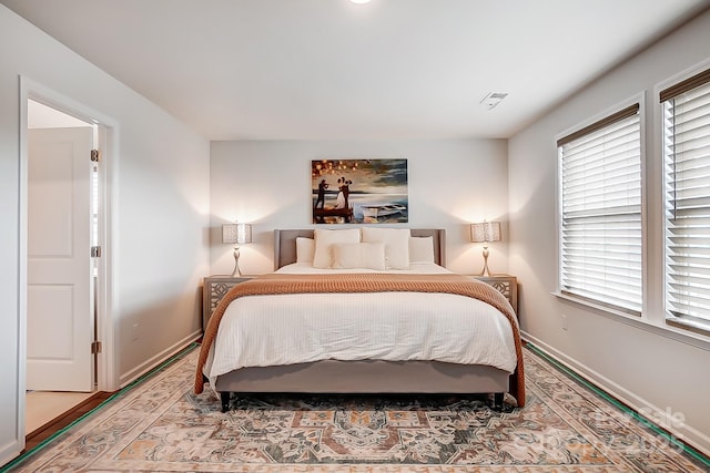 bedroom featuring visible vents and baseboards