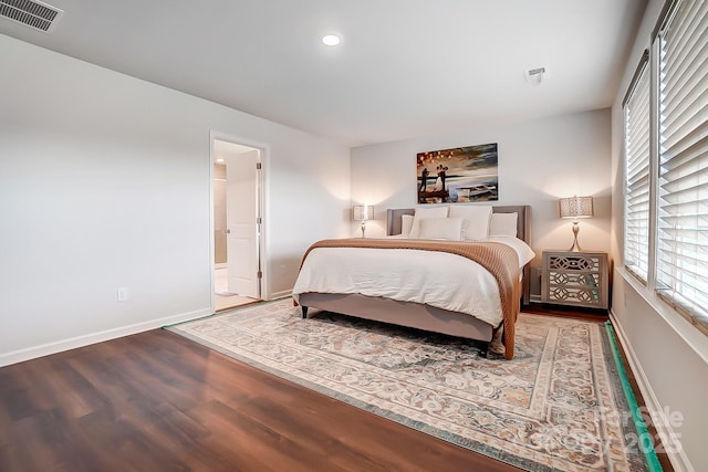 bedroom with recessed lighting, wood finished floors, visible vents, and baseboards