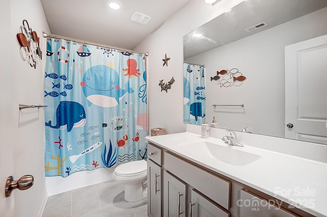 bathroom featuring toilet, vanity, visible vents, and tile patterned floors