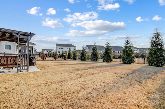 view of yard featuring a residential view, a patio area, and fence