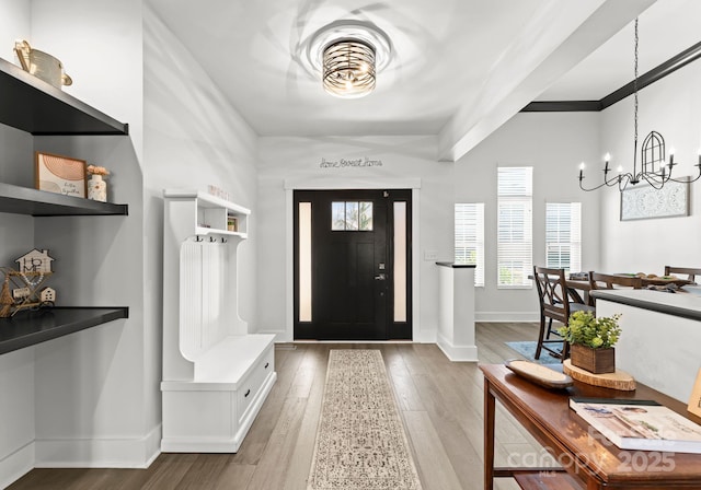 foyer featuring hardwood / wood-style flooring and a chandelier