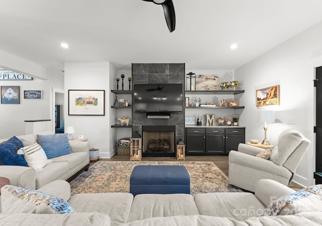 living room featuring a fireplace and dark hardwood / wood-style flooring