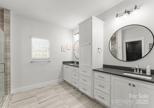 bathroom with vanity and a shower with shower door