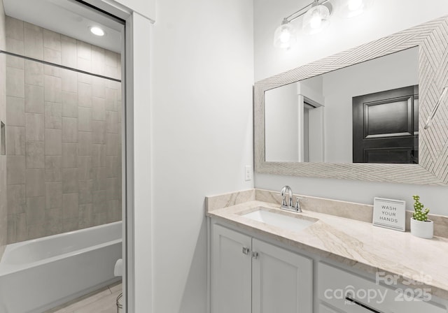 bathroom featuring vanity and tiled shower / bath combo