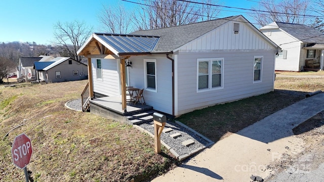 view of front of home featuring a shingled roof and board and batten siding