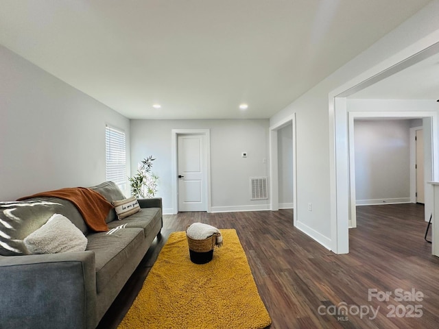 living room featuring recessed lighting, visible vents, dark wood finished floors, and baseboards