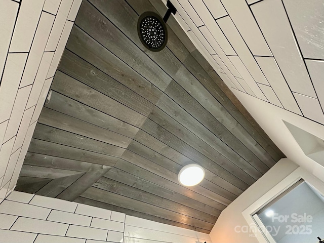 interior details featuring wooden ceiling and a tile shower