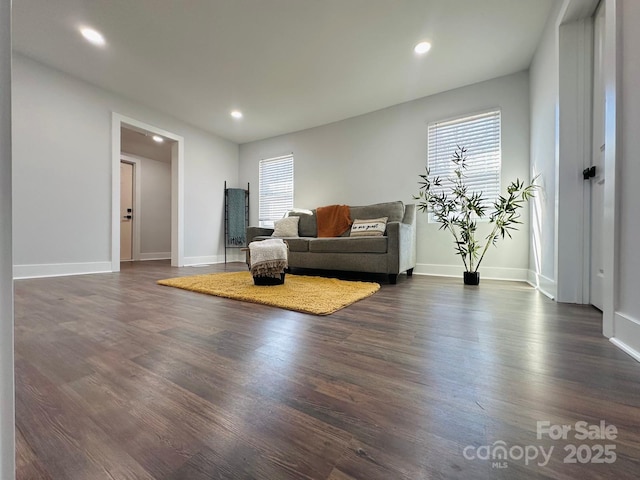 living room with recessed lighting, dark wood finished floors, and baseboards