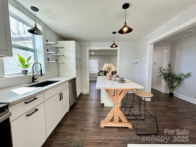 kitchen featuring white cabinets, a sink, open shelves, and hanging light fixtures