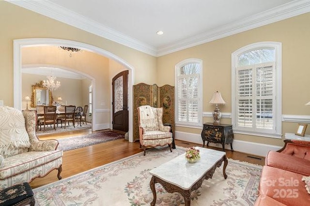 sitting room featuring wood-type flooring, a chandelier, and plenty of natural light