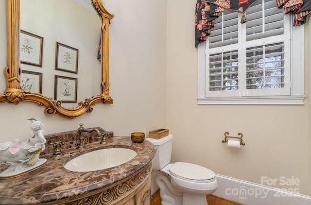 bathroom featuring vanity and toilet